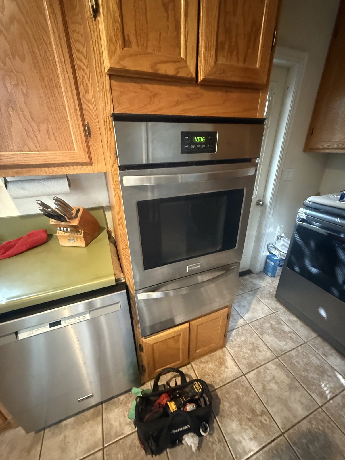 Frigidaire wall oven with A&Y technician tool bag during an oven repair visit