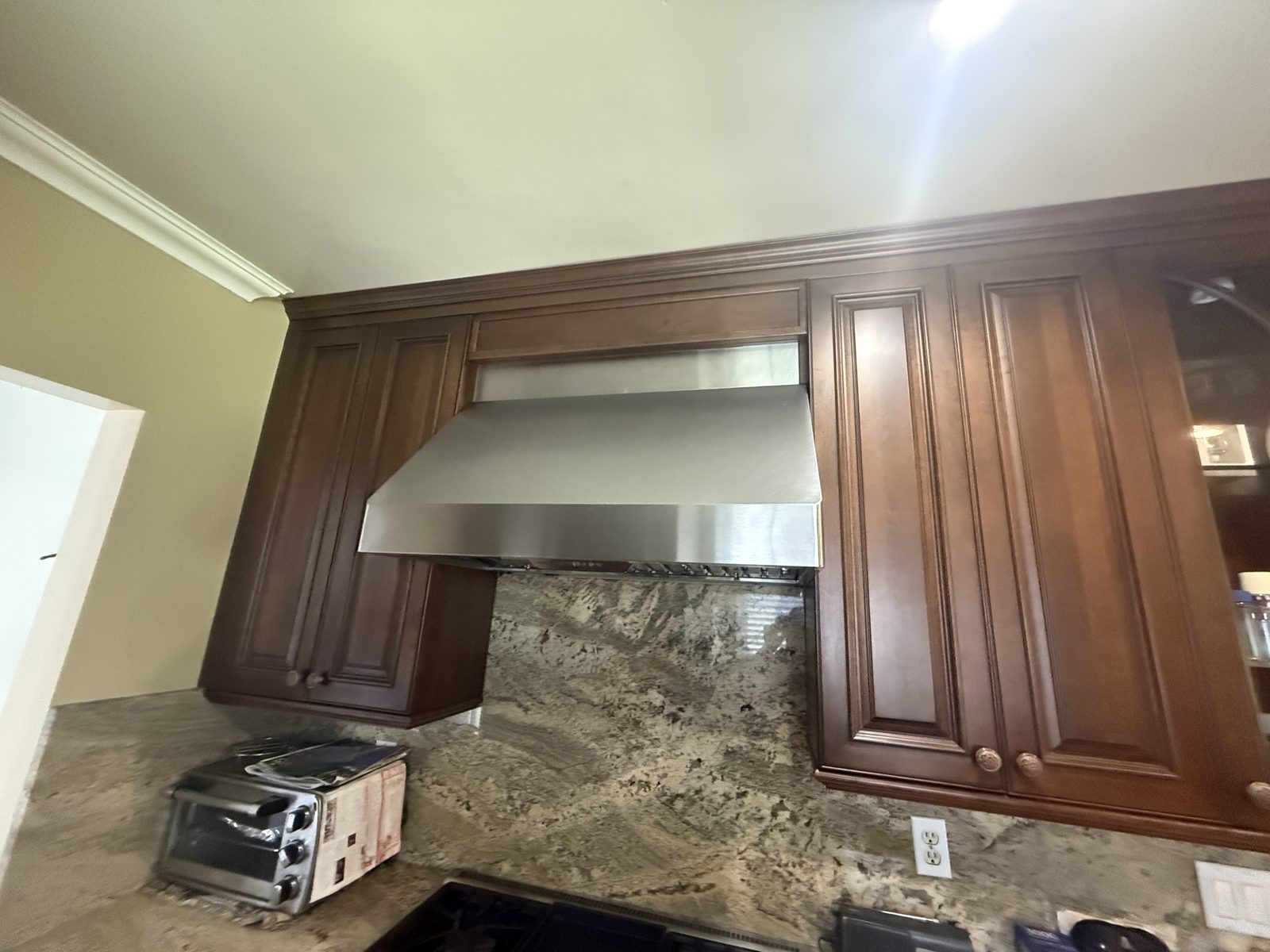 Professional stainless range hood and cooking area serviced by A&Y Appliances