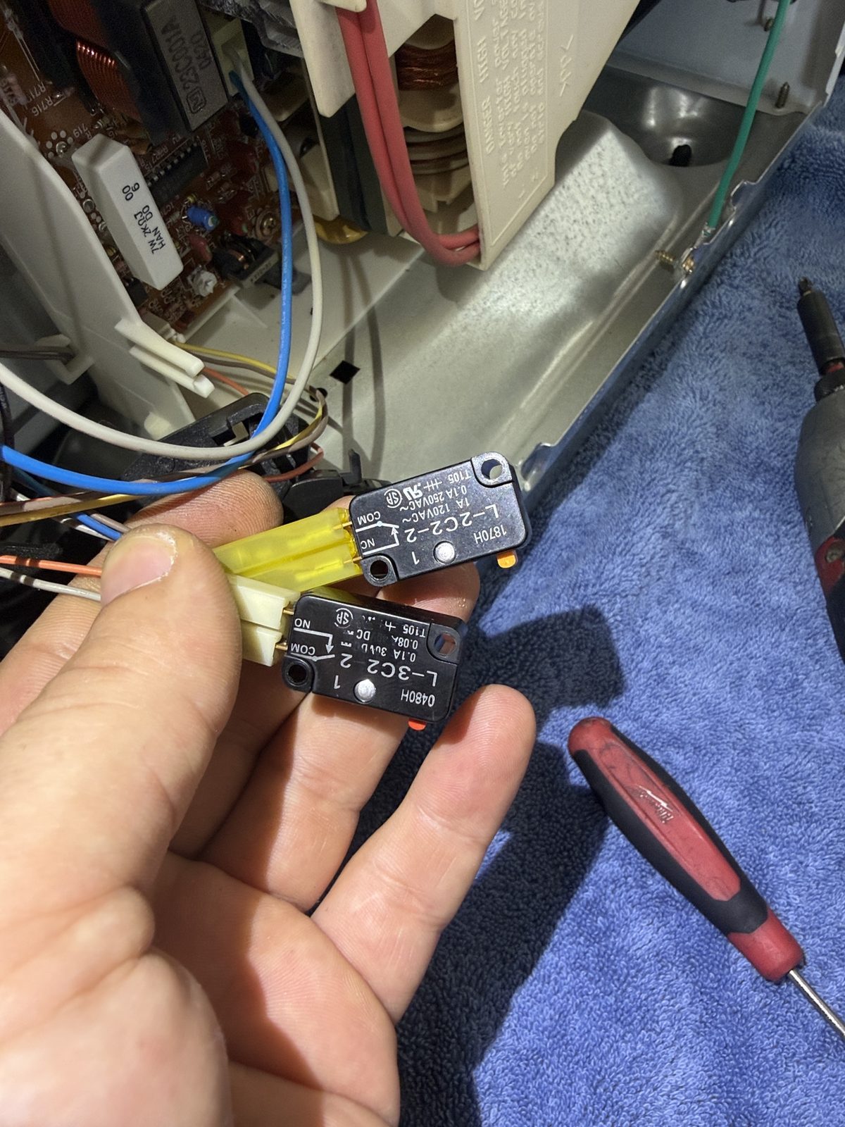 Two door interlock microswitches removed from a Thermador built-in microwave for testing during A&Y Appliances repair in San Marino
