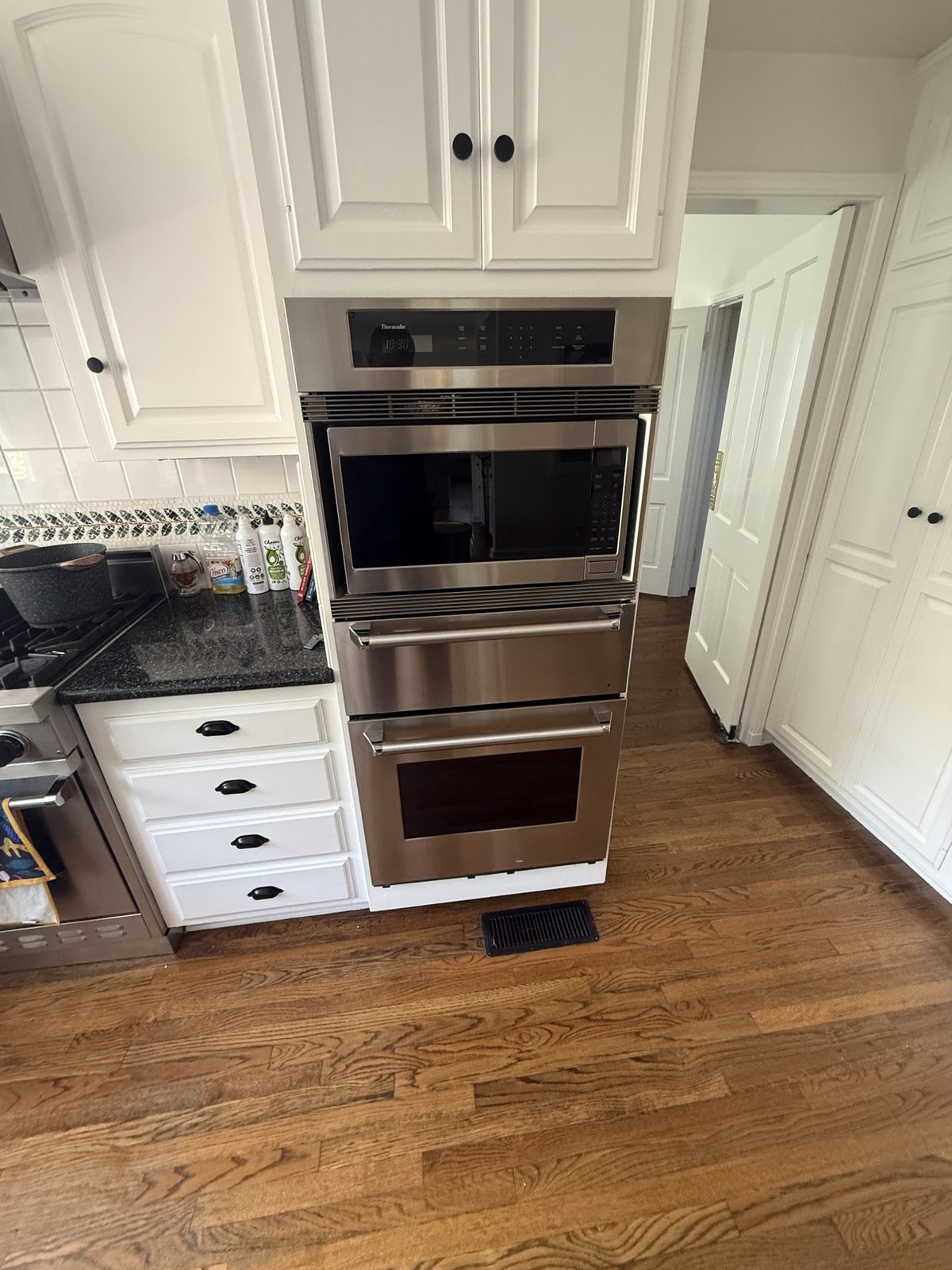 Built-in Thermador microwave, warming drawer and wall oven combination unit in a San Marino kitchen serviced by A&Y Appliances