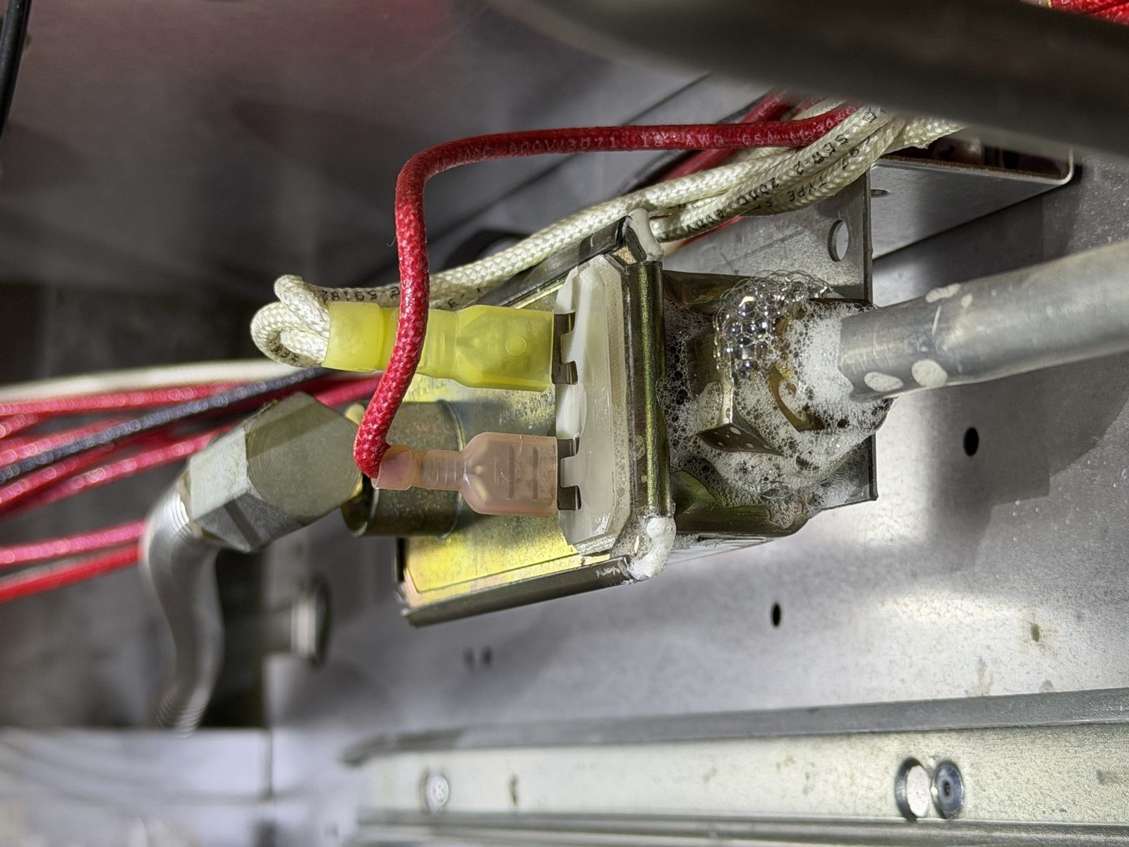 Soap bubble leak test revealing a gas leak at the oven safety valve of a Viking range during A&Y Appliances diagnosis